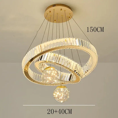 Modern gold pendant light with brushed stainless finish featuring two interlocking crystal rings and spherical fixtures