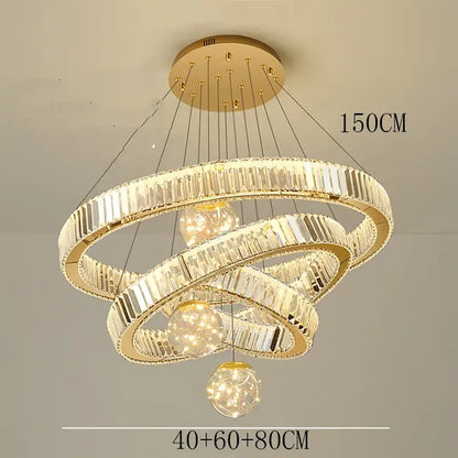 Modern gold crystal pendant light with three interlocking rings and brushed stainless finish for dining room use