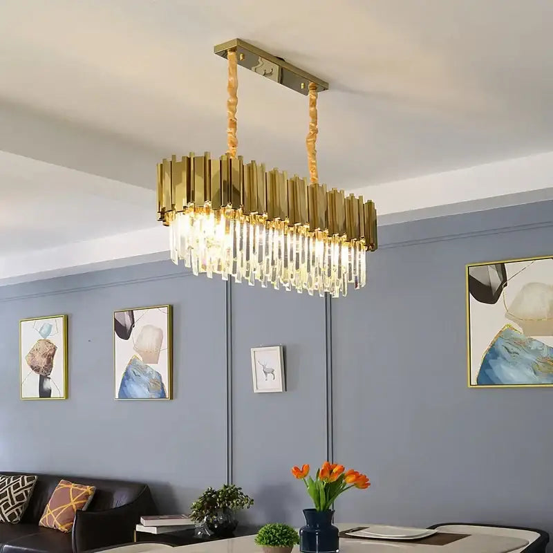 Modern gold crystal oval round chandelier with gold-toned rectangular frame and cascading clear crystal prisms decorbites crystal oval