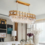 Modern gold-toned rectangular island pendant light with crystal droplets and oval suspension for dining room