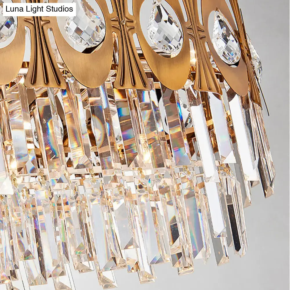 Modern gold island pendant light with faceted crystal teardrop pendants and cascading glass rods oval suspension