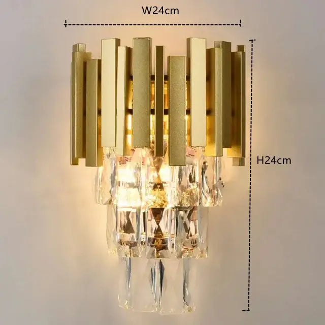 Modern gold crystal pendant chandelier with gold-toned wall sconce featuring vertical brass bars and cascading prisms