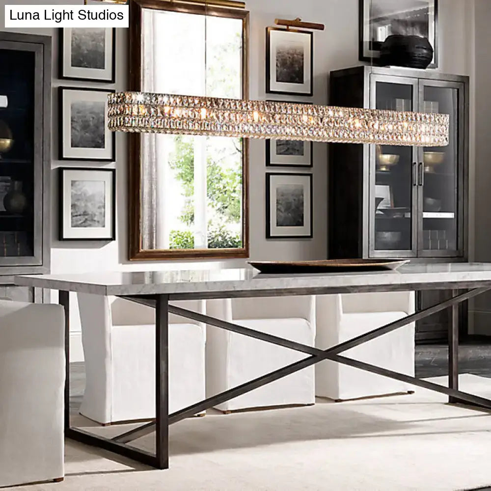 Modern gold crystal pendant chandelier with sleek metallic frame hanging above dining table 110v-120v use