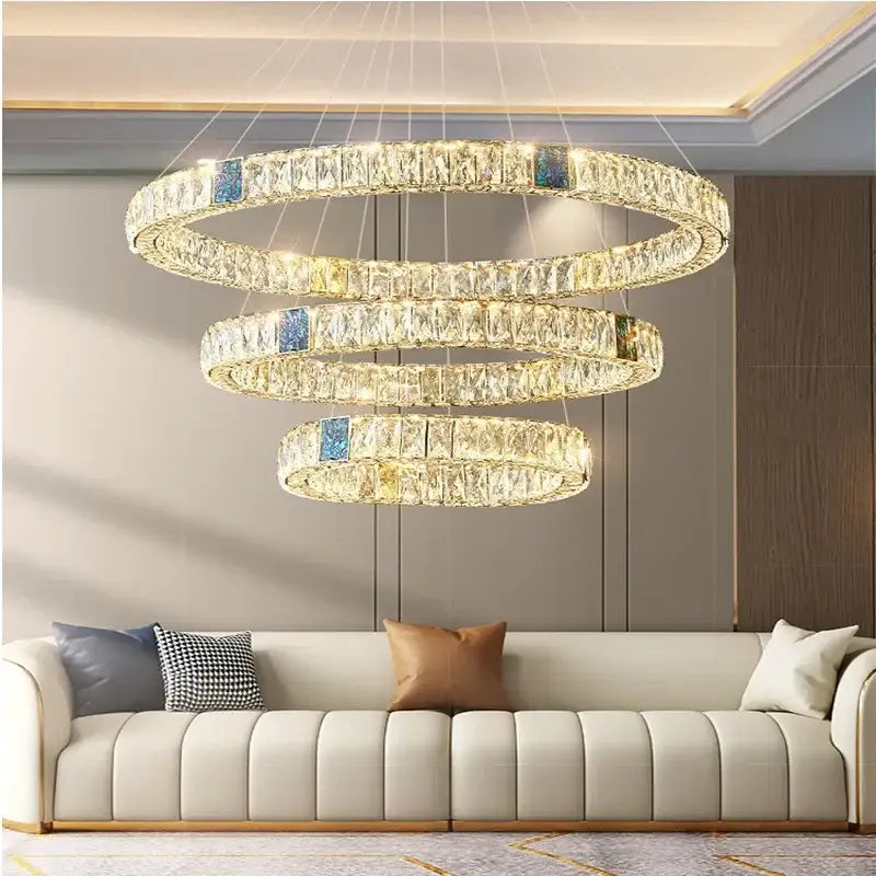 Modern gold crystal pendant chandelier led dining room light with multi-tiered faceted crystals and blue accent panels above sofa