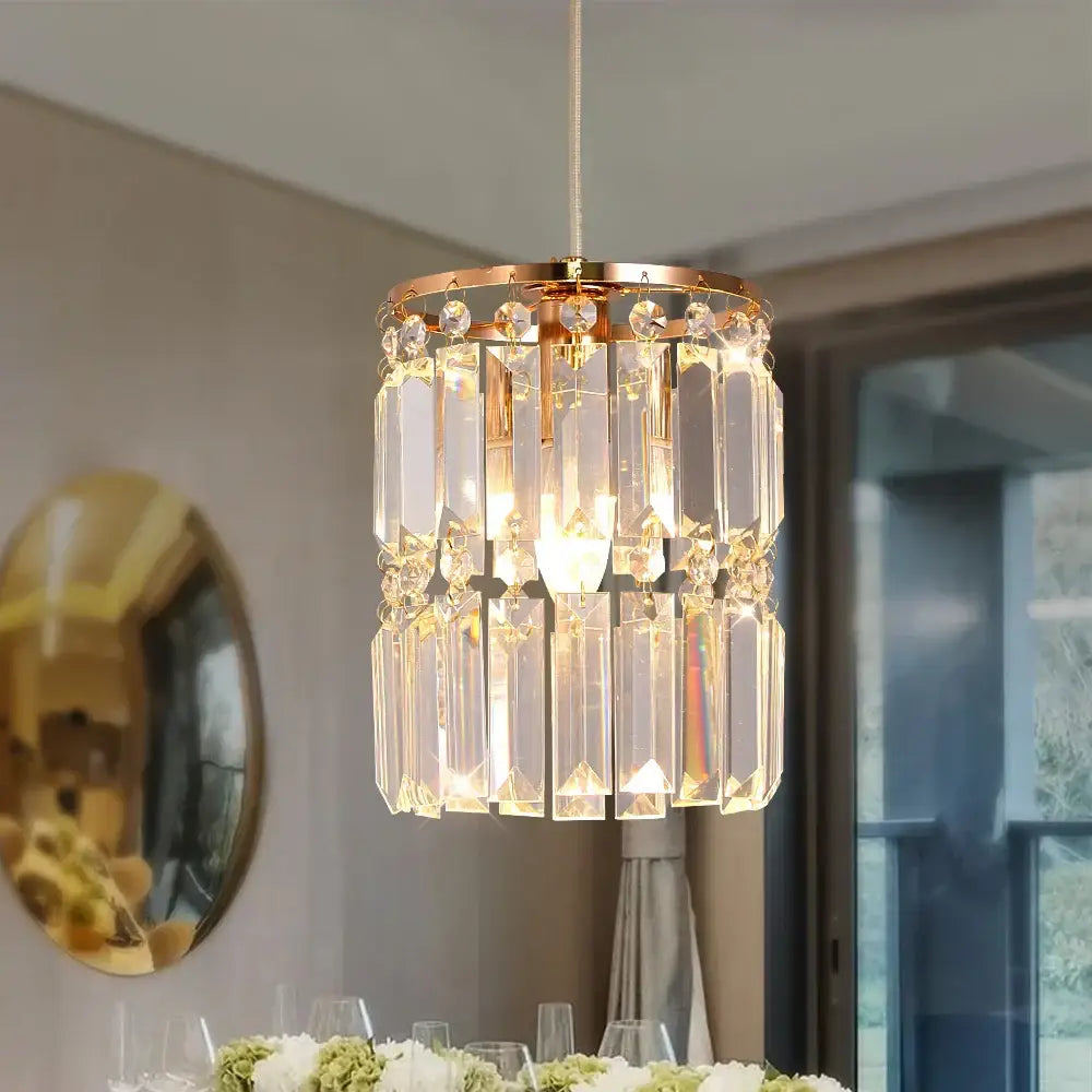 Modern gold crystal pendant light with rose gold frame and clear faceted crystals for dining room chandelier