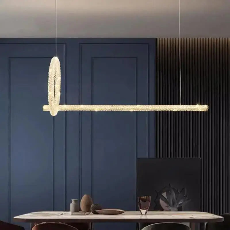 Modern gold-toned decorbites crystal pendant lights with sleek elongated bar and oval pendant for luxury dining room decor