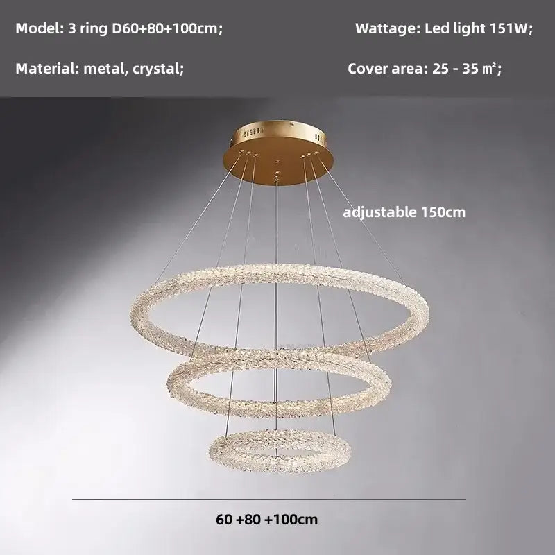 Modern gold crystal pendant lights featuring a gold-toned three-ring chandelier with crystal-encrusted rings and metallic mount