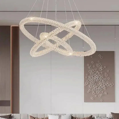 A modern gold crystal pendant light with interlocking rings suspended by thin wires for luxury dining room decorbites crystal pendant