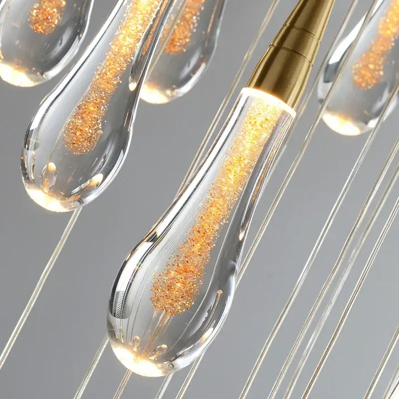 Modern gold crystal raindrop pendant lights with clear glass teardrop design and golden glitter for foyer chandelier