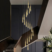 Modern gold crystal raindrop pendant lights featuring golden teardrop-shaped clear glass with metallic accents for foyer chandelier