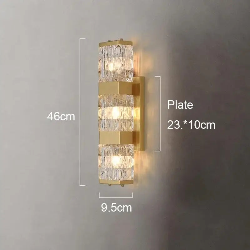 Modern gold crystal rectangle wall lamp featuring stacked crystal segments and a brass plate for luxury bedroom decorbites lighting