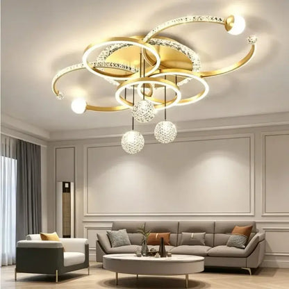 Modern gold crystal ring chandelier pendant light with interlocking rings, dimmable led bulbs, and crystal globe pendants