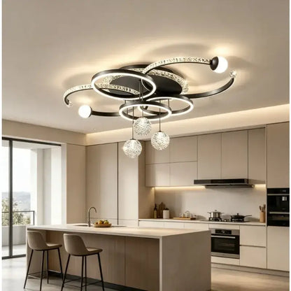 Modern black and crystal pendant light with circular rings and dimmable led bulbs for dining room use