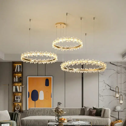 Three elegant gold-toned decorbites crystal ring led chandeliers with crystal droplets for modern dining room decor