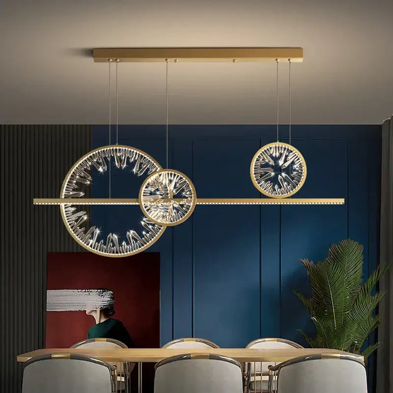 Modern gold crystal ring led chandelier featuring three circular crystal-encrusted pendants for dining room decorbites decor