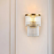 Modern gold wall lamp with cascading clear crystal rods for elegant dining room lighting