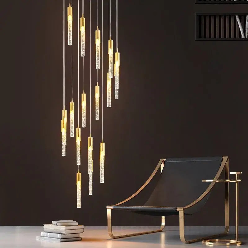 Modern gold crystal rotating staircase chandelier with hanging cylindrical glass tubes in gold metal frame emitting warm light