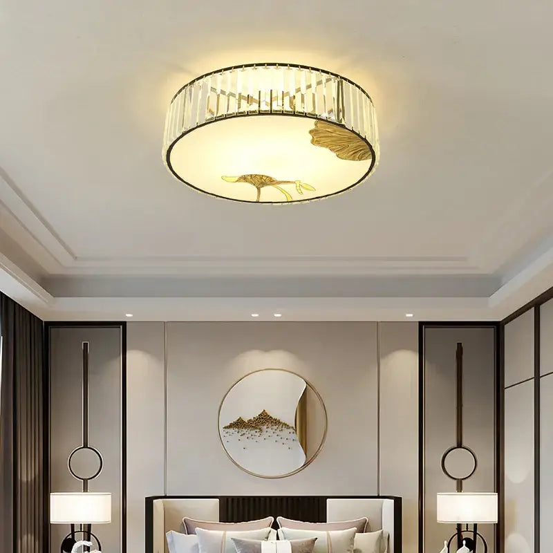 Modern gold crystal round ceiling light with leaf and bird design framed by decorbites crystal round bars