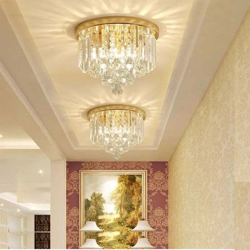 Two elegant gold-toned decorbites crystal round ceiling lights with cascading clear glass prisms for luxe living room decor