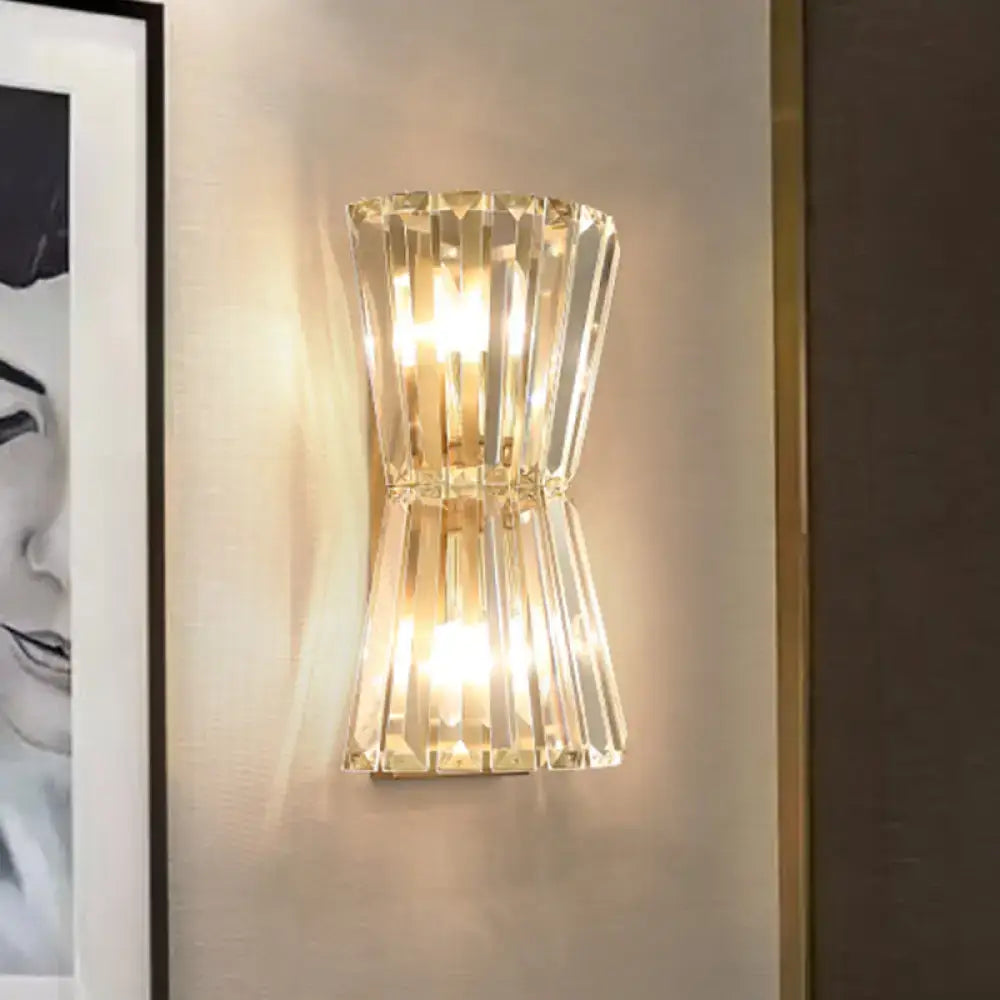A sleek modern gold crystal shade wall mounted light with faceted crystal and dual light design for corridor sconce