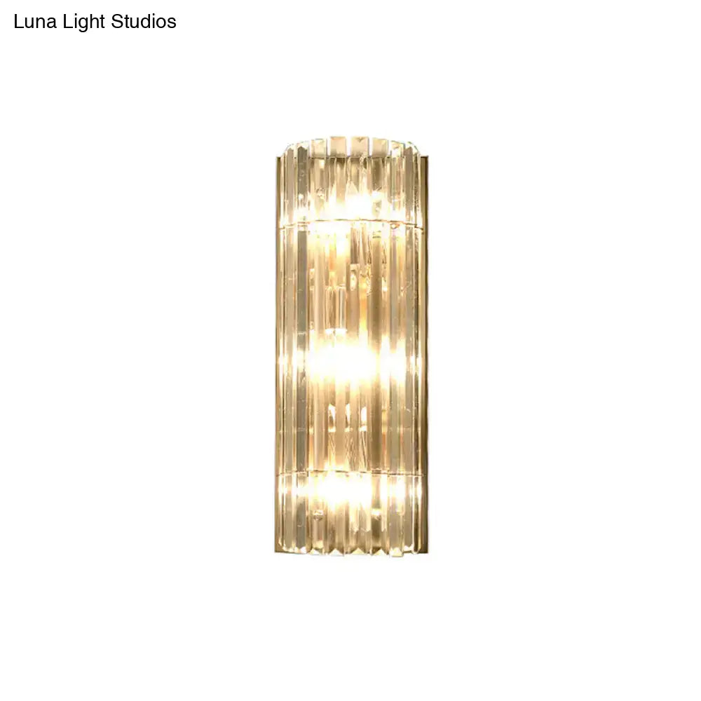 Modern gold crystal shade wall scone with vertical crystal rods and warm led incandescent fluorescent glow for living room