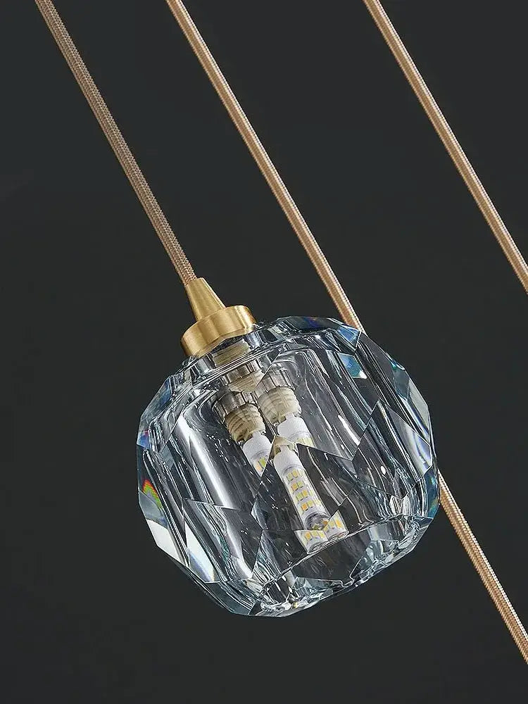 Modern gold crystal stainless steel staircase chandelier featuring a clear faceted crystal pendant light with gold fixture