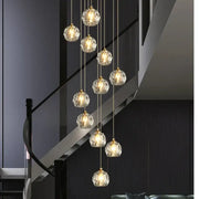 Modern gold crystal stair football shaped chandelier with multiple faceted crystal globe lights suspended by chains