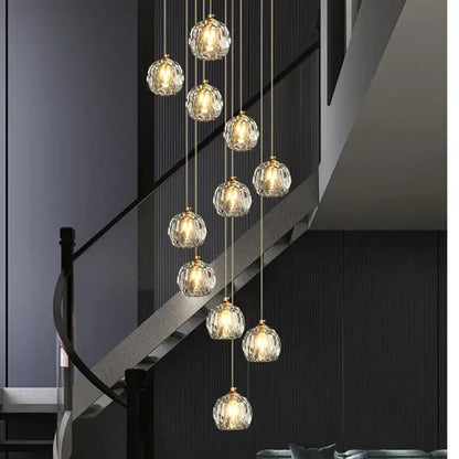 Modern gold crystal stair football shaped chandelier with multiple faceted crystal globe lights suspended by chains