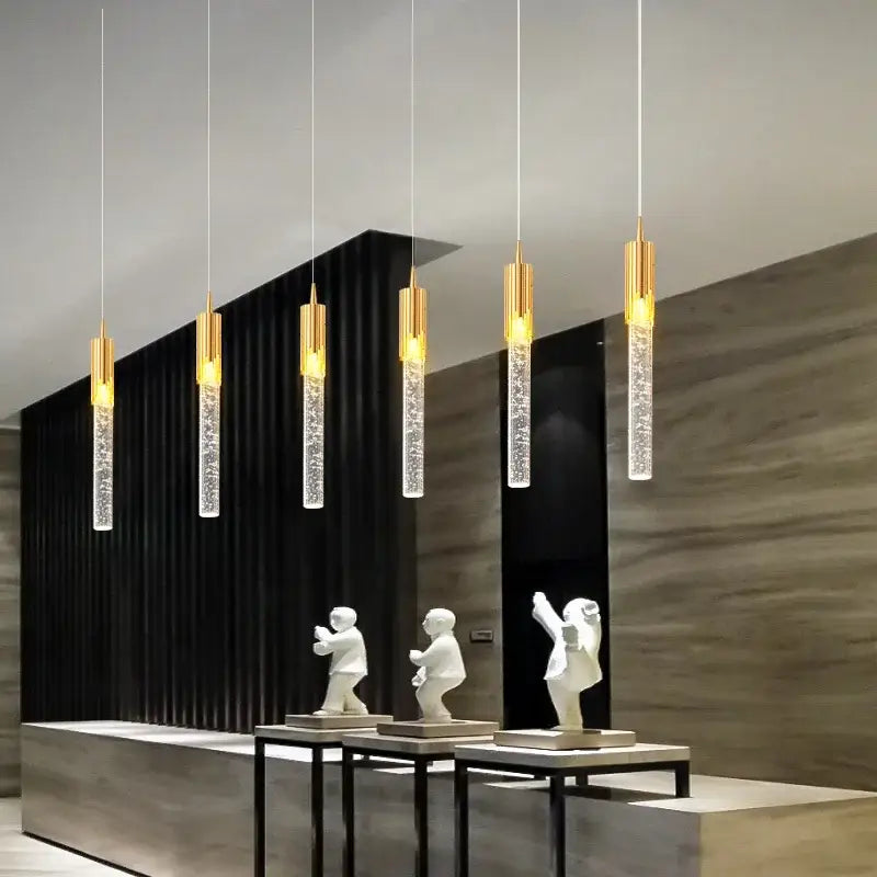 Five modern pendant lights with gold-finished tops and crystal bodies in decorbites crystal staircase chandelier design