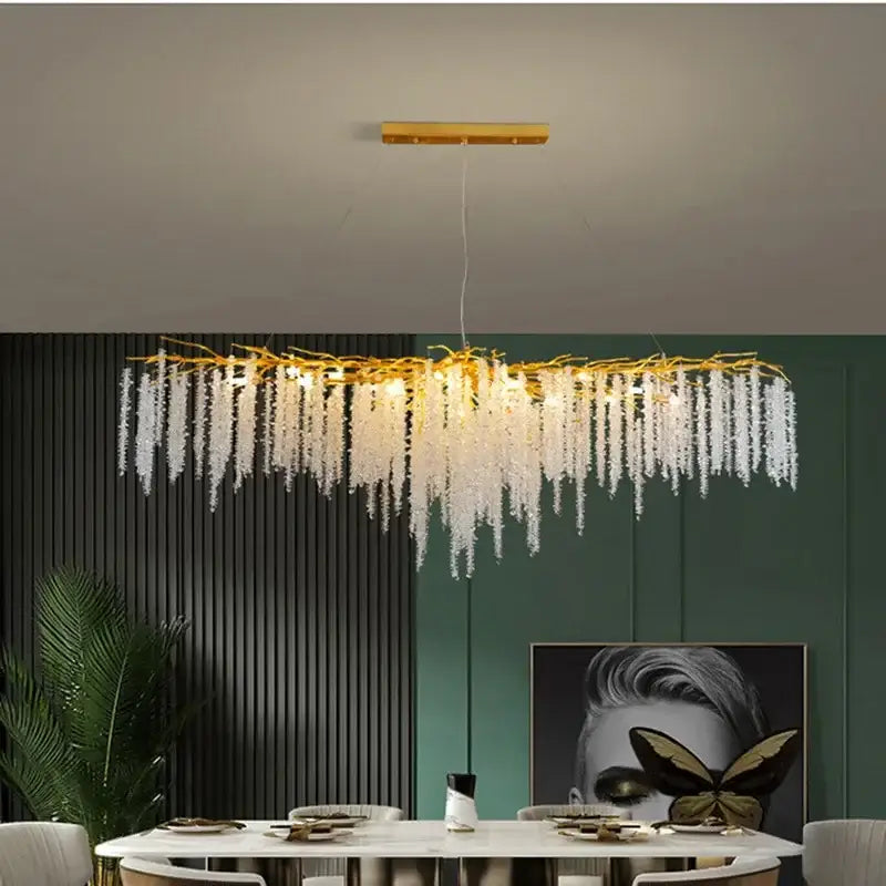 Modern gold crystal tassel led pendant light featuring a gold-toned chandelier with cascading white crystal strands for dining room decorbites