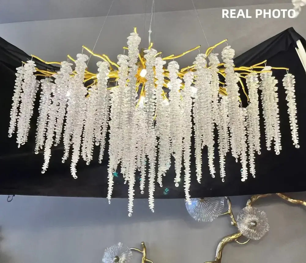 Modern gold crystal tassel led pendant light featuring a cascading glass bead chandelier for dining room decorbites decor