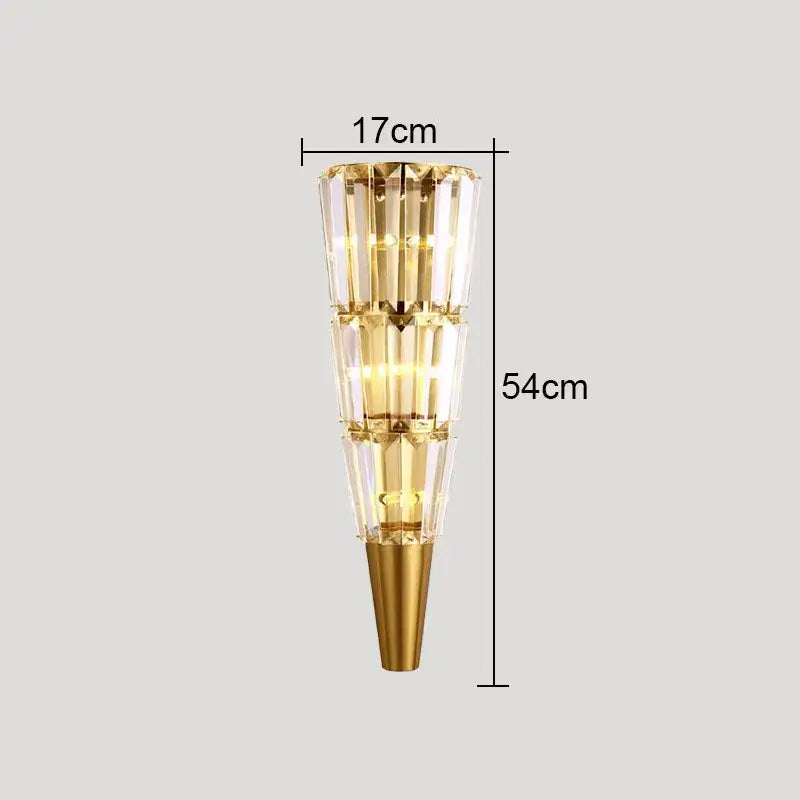 Modern gold crystal torch wall lamp with tiered faceted glass panels and conical base for elegant living room decorbites crystal torch
