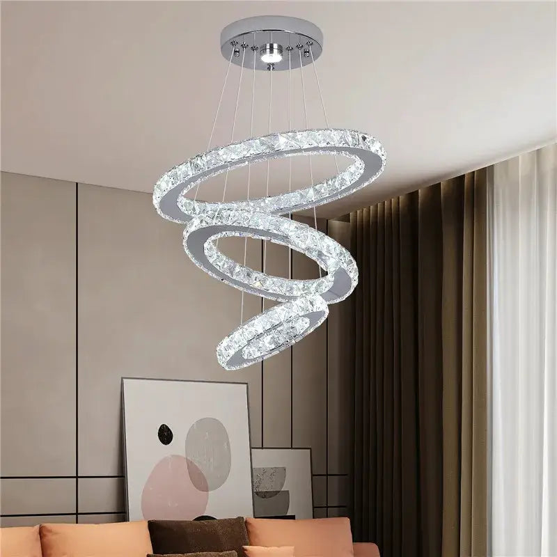 Modern gold decorbites crystal triangle chandelier with three interlocking crystal rings and sleek chrome frame for living room decor