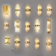 Modern gold crystal wall lamp with clear glass prisms in vertical stacks emitting warm light for decorbites crystal wall use