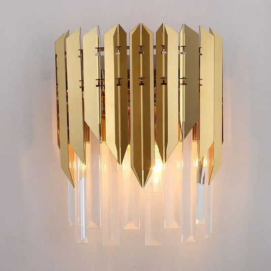 Modern gold metallic wall lamp with vertical angular panels and hanging crystal prisms decorbites crystal wall lamp
