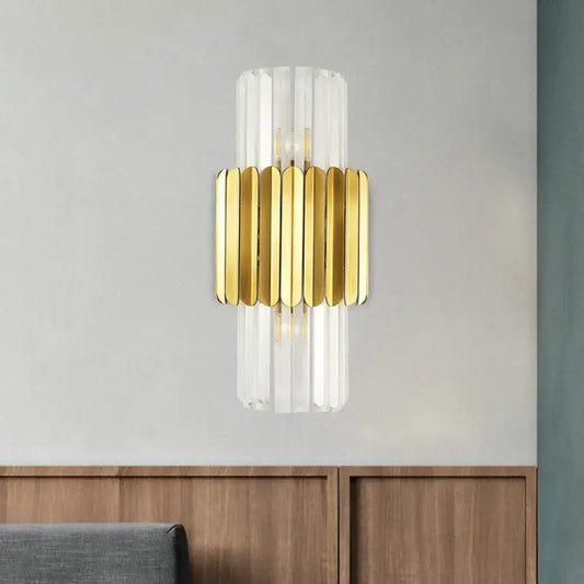 Modern gold crystal wall lamp with clear glass cylinder and gold-toned metallic slats for bedroom sconce lighting
