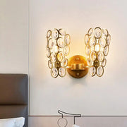 Modern gold crystal wall lamp bedroom sconce featuring cascading clear crystal discs in a gold-toned finish