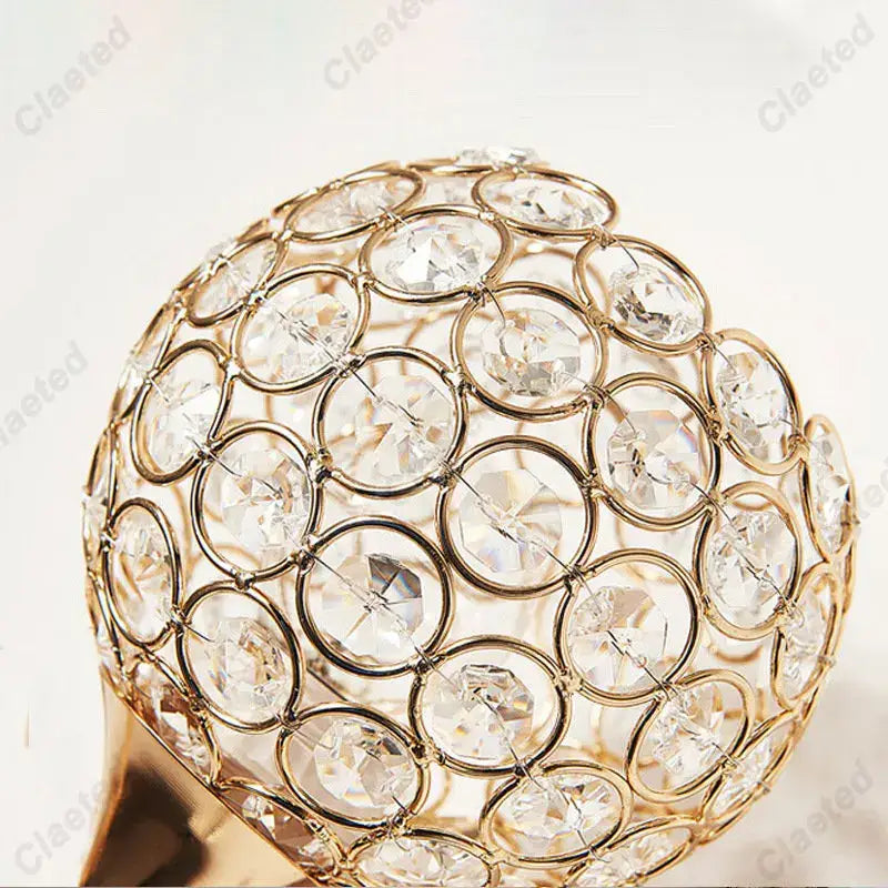 Modern gold crystal wall lamp featuring a spherical metal frame with clear faceted crystals for elegant decorbites crystal wall lighting