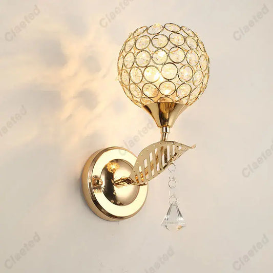 Modern gold crystal wall lamp with spherical crystal globe and dangling clear teardrop for bedroom decorbites crystal wall