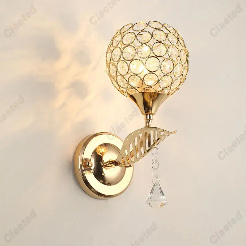 Modern gold crystal wall lamp with spherical crystal globe and dangling clear teardrop for bedroom decorbites crystal wall