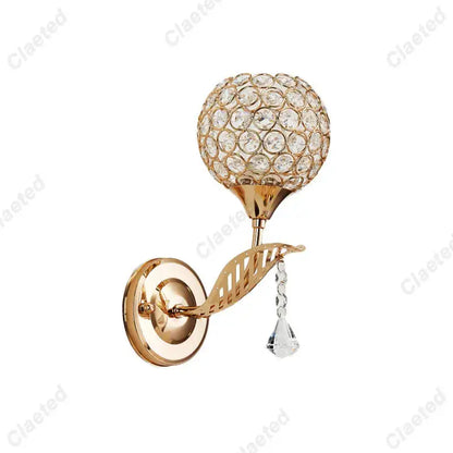Modern gold wall lamp featuring a spherical crystal globe and dangling teardrop for elegant bedroom decorbites crystal wall use