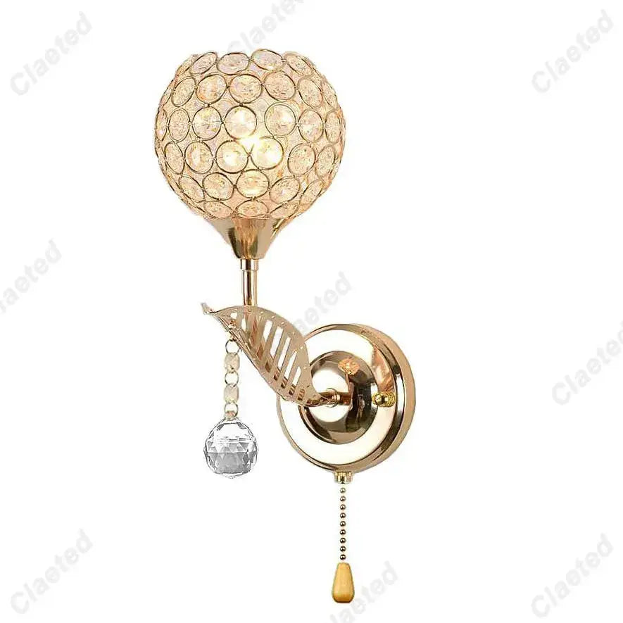 Modern gold crystal wall lamp with spherical globe and decorative leaf accent for elegant bedroom decorbites crystal wall lamp