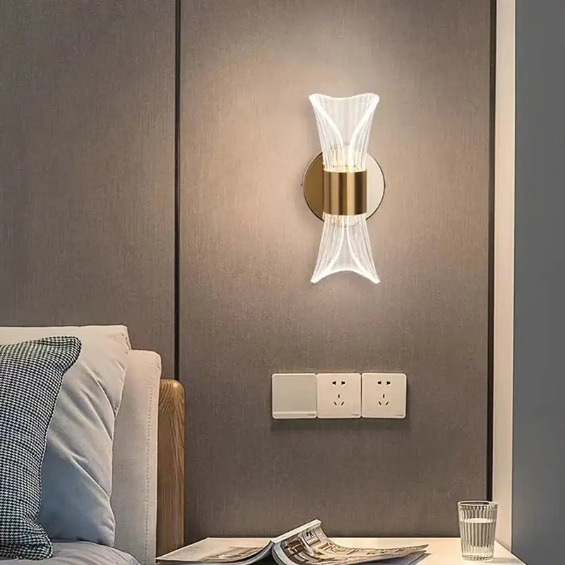 Modern gold crystal wall lamp with clear fluted glass shade and gold-toned metal base for elegant bedroom decorbites crystal wall design