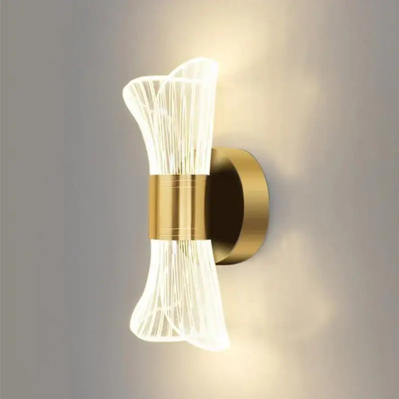 Modern gold crystal wall lamp with sculptural translucent ribbed glass shade emitting warm ambient light decorbites crystal wall lamp
