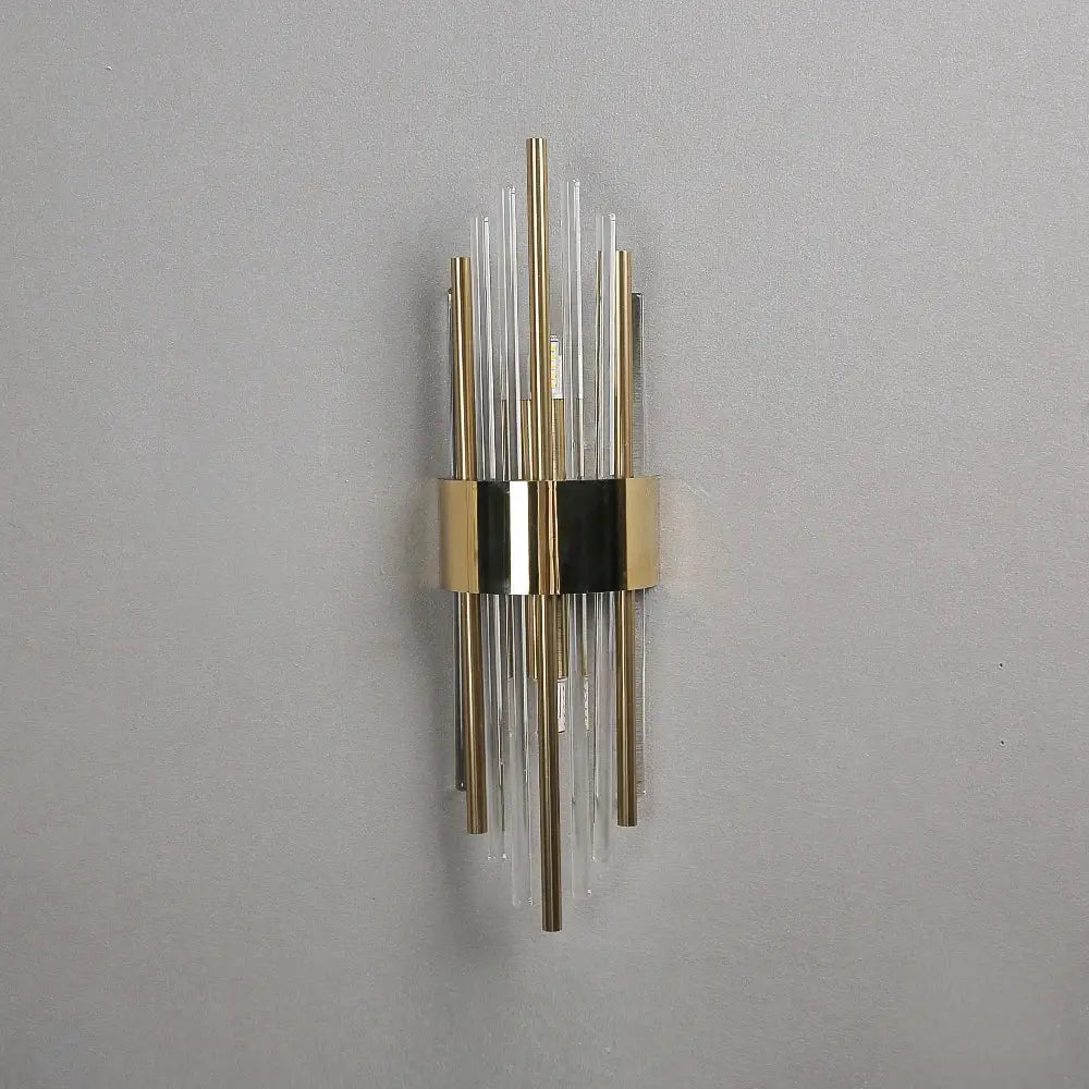 Modern gold crystal wall lamp featuring vertical clear and brass-colored glass rods for elegant bedroom decorbites crystal wall lamp