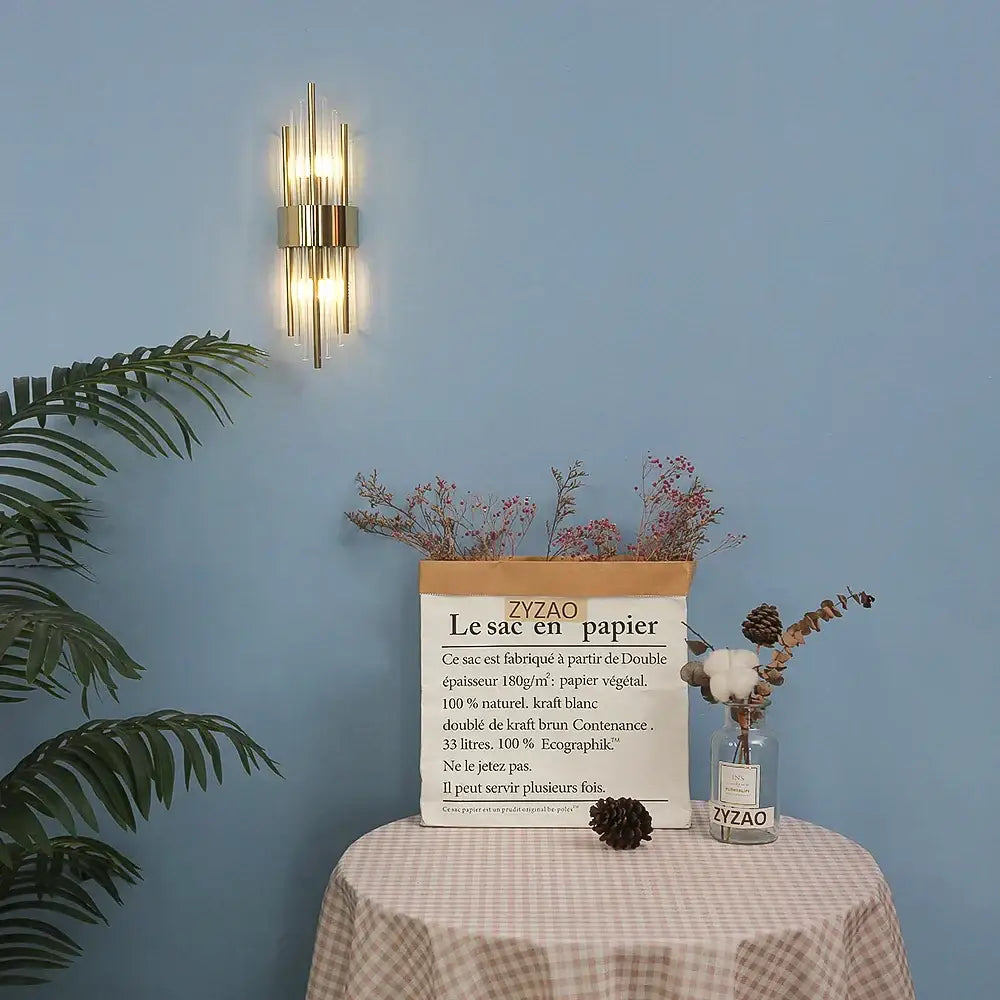 Modern gold crystal wall lamp with vertical glass tubes and a central metallic frame for bedroom decorbites crystal wall lamp