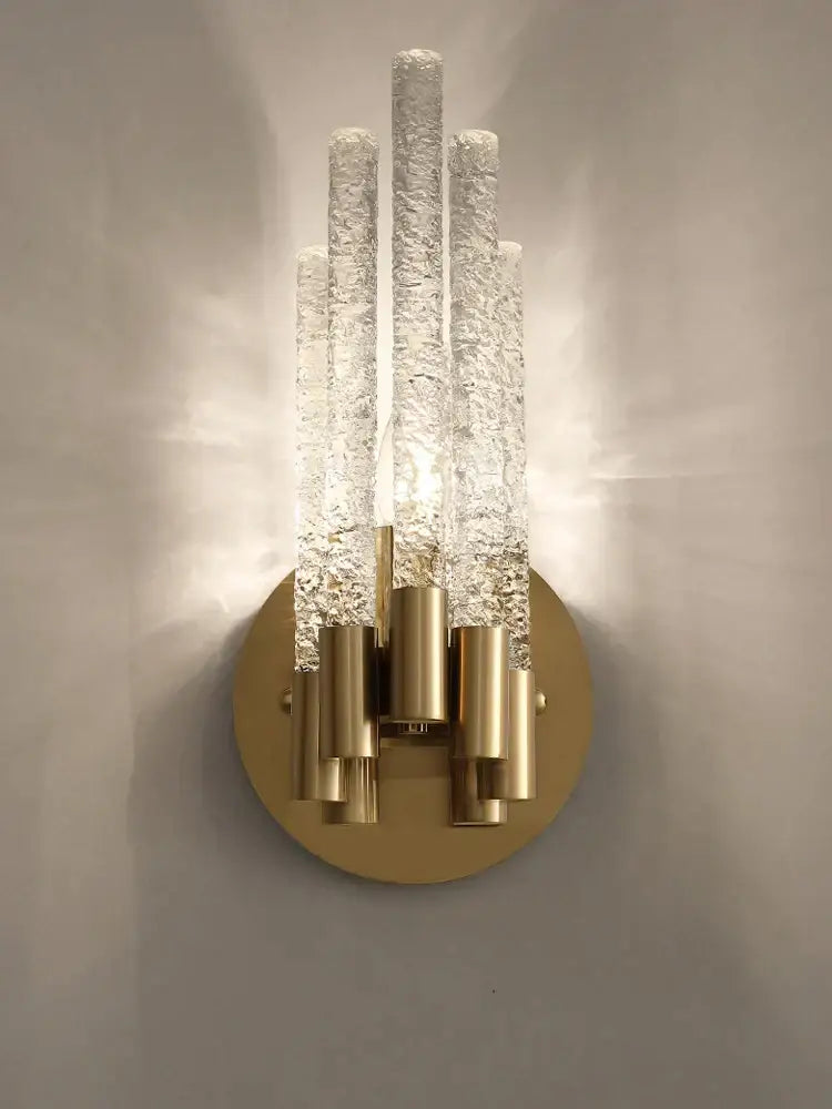 Modern gold crystal wall lamp with five textured clear glass tubes and circular base for elegant living room decorbites crystal wall lamp