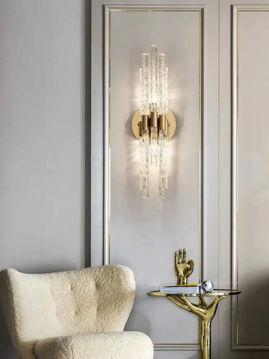 Modern gold crystal wall lamp with vertical crystal rods emitting warm glow for living room decorbites crystal wall lamp