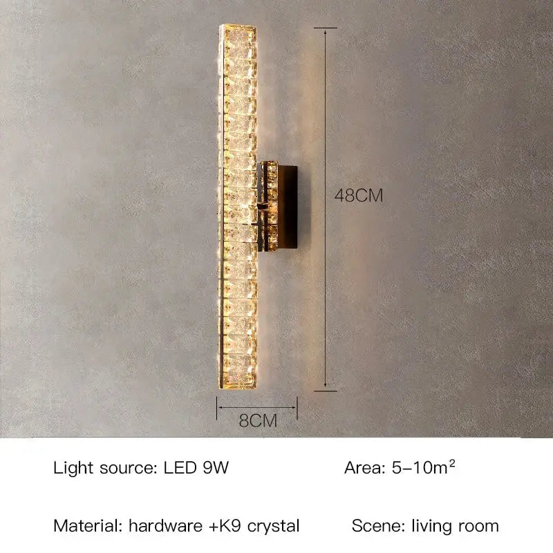 Modern gold crystal wall lamp with stacked k9 panels and dark hardware emitting warm light for living room decorbites crystal wall