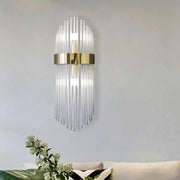 Modern gold crystal wall lamp with clear glass rods and metallic frame for elegant living room lighting